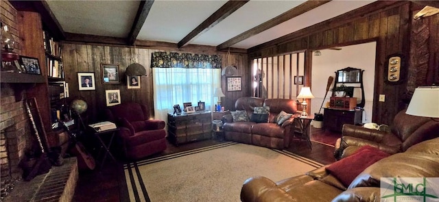 living room featuring beamed ceiling, a brick fireplace, and wooden walls