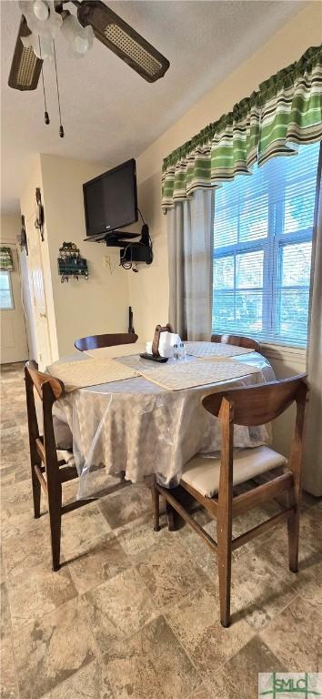 dining space featuring ceiling fan