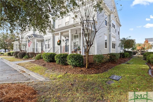 view of front of property with a front yard and a porch