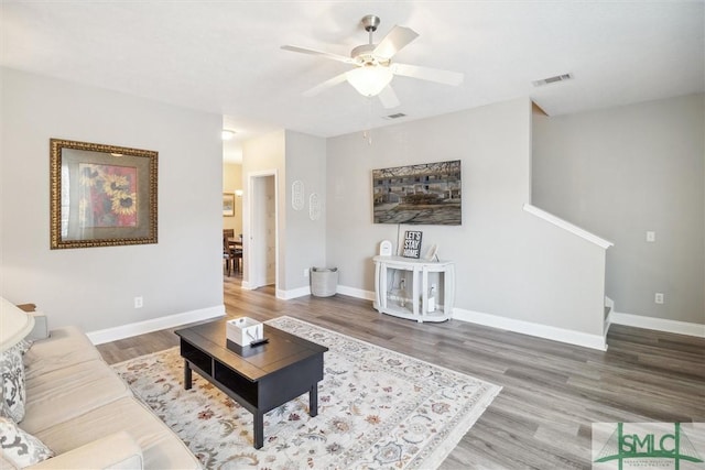 living room with ceiling fan and hardwood / wood-style floors