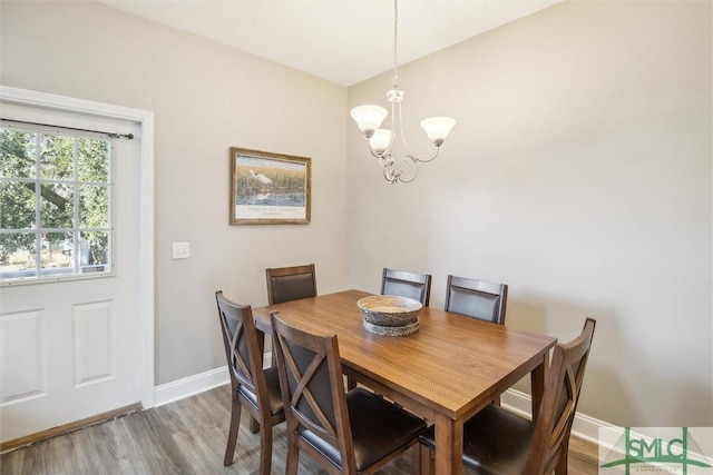 dining space featuring a chandelier and hardwood / wood-style flooring