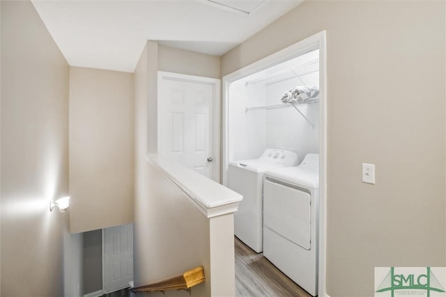 washroom featuring independent washer and dryer and light hardwood / wood-style flooring