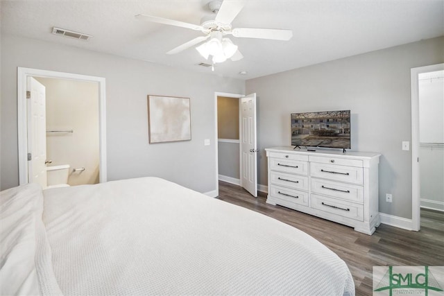 bedroom featuring ceiling fan, ensuite bathroom, and dark hardwood / wood-style floors