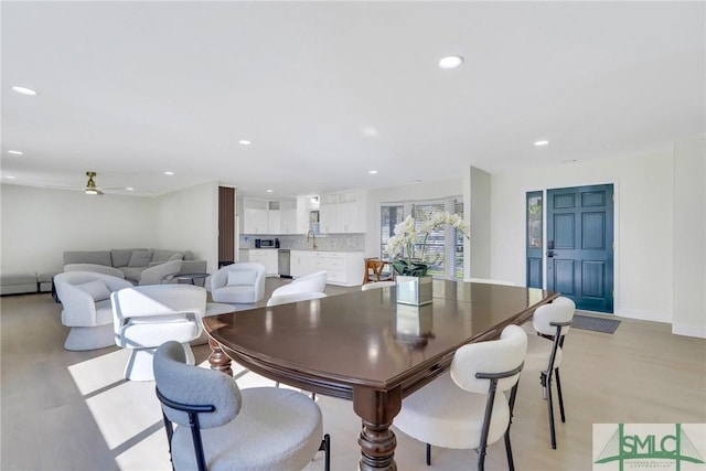 dining space with ceiling fan, sink, and a baseboard radiator