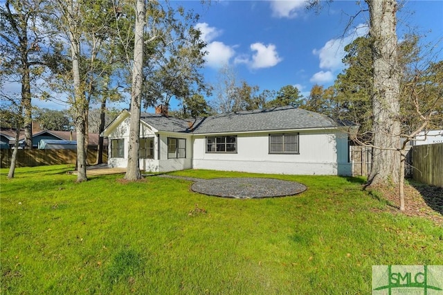 rear view of property with a yard