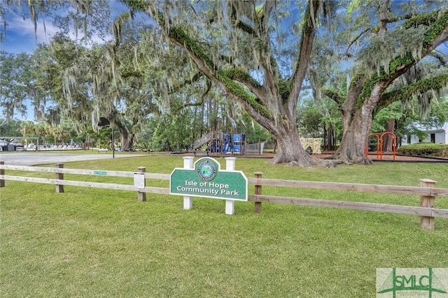 view of home's community featuring a yard and a playground