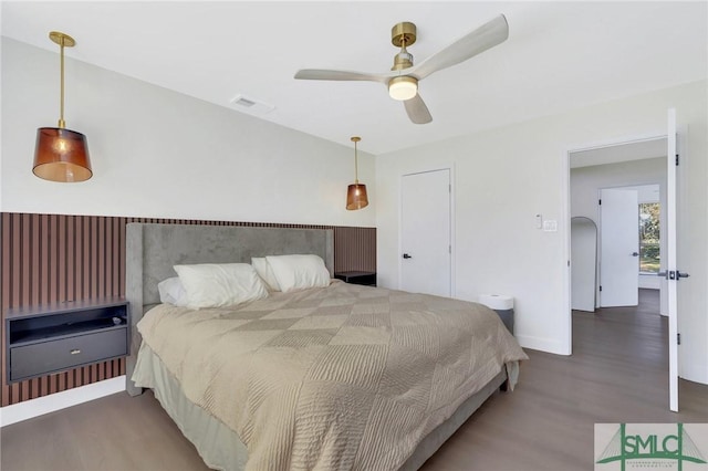 bedroom with ceiling fan and dark hardwood / wood-style flooring