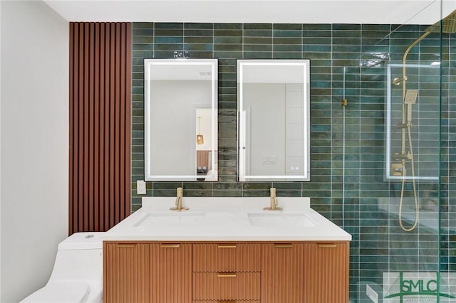 bathroom with a tile shower, vanity, and toilet