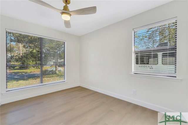 empty room with hardwood / wood-style flooring and ceiling fan