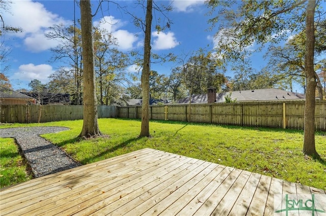 wooden terrace featuring a yard