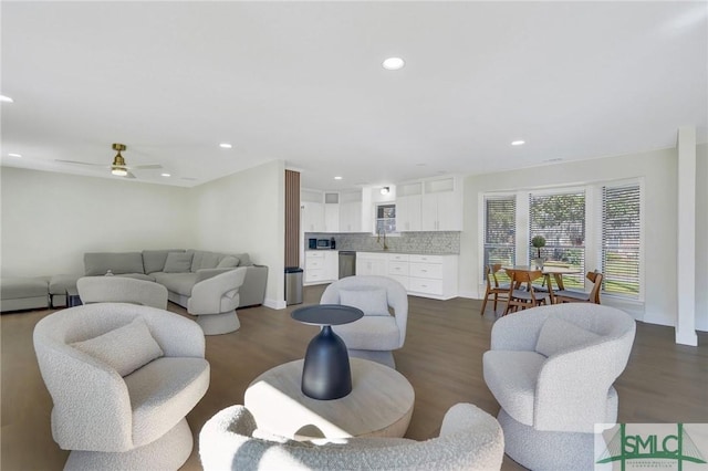 living room featuring dark hardwood / wood-style flooring and ceiling fan