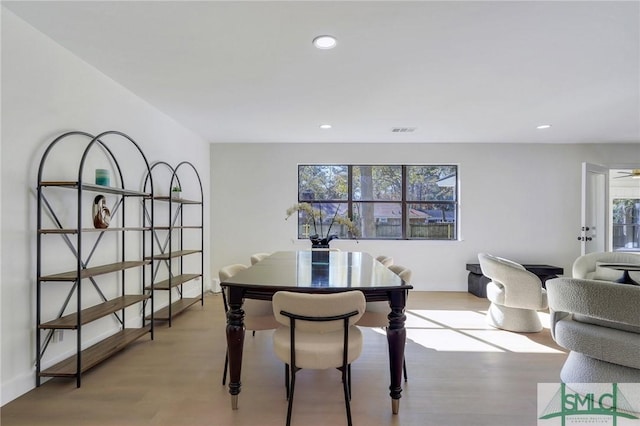 dining room featuring light hardwood / wood-style flooring and ceiling fan