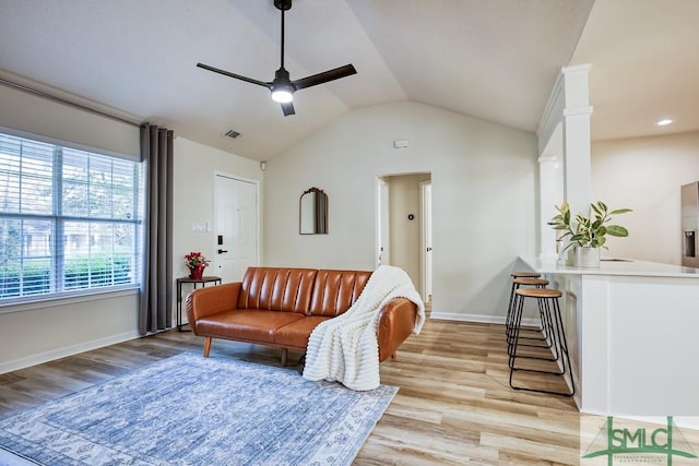 living room with vaulted ceiling, ceiling fan, and light hardwood / wood-style floors