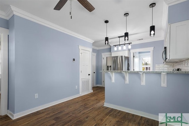 kitchen with crown molding, white cabinets, stainless steel appliances, and dark hardwood / wood-style floors