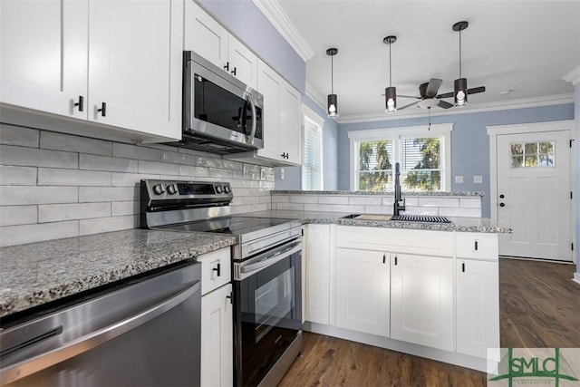 kitchen featuring stainless steel appliances, dark hardwood / wood-style floors, crown molding, decorative light fixtures, and white cabinets