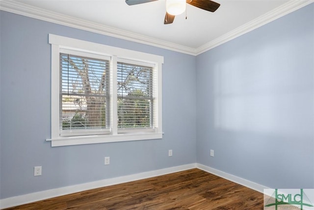 spare room with a wealth of natural light, dark hardwood / wood-style flooring, ceiling fan, and ornamental molding