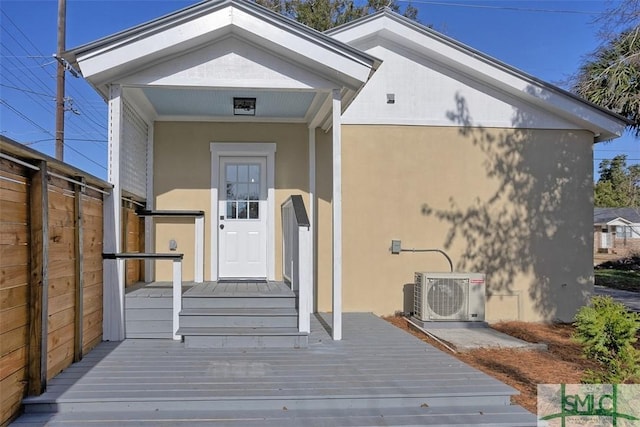 property entrance with ac unit and a deck