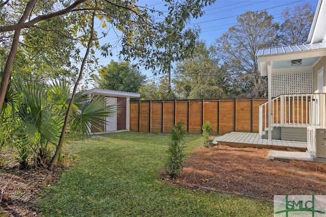 view of yard featuring a storage shed and a wooden deck