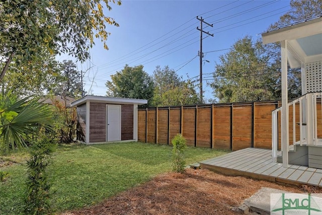 view of yard with a deck and a storage unit