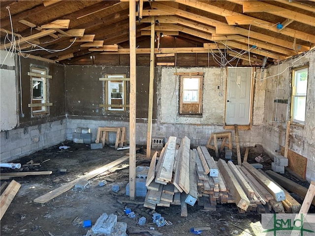 misc room with a healthy amount of sunlight and lofted ceiling