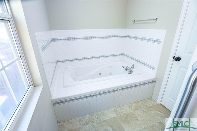 bathroom featuring tile patterned floors and tiled tub