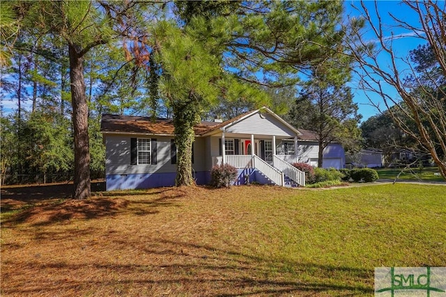 ranch-style house featuring covered porch, a front yard, and a garage