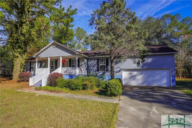 view of front of house with covered porch, a front yard, and a garage