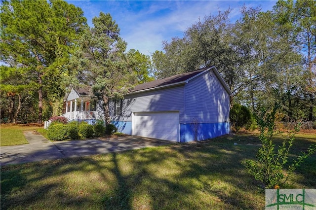 view of side of home with a lawn, a porch, and a garage