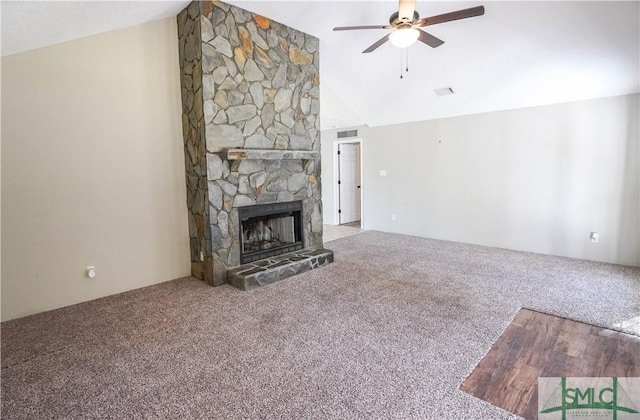 unfurnished living room featuring a fireplace, carpet floors, ceiling fan, and lofted ceiling