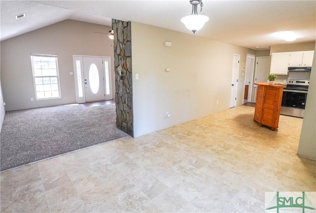 kitchen featuring stainless steel range with electric stovetop, lofted ceiling, white cabinets, ceiling fan, and light colored carpet