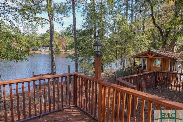 wooden terrace featuring a water view