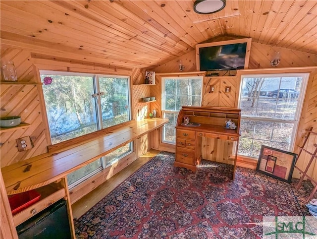 sitting room featuring wood ceiling, wooden walls, and vaulted ceiling