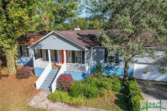 view of front of property featuring a porch and a garage