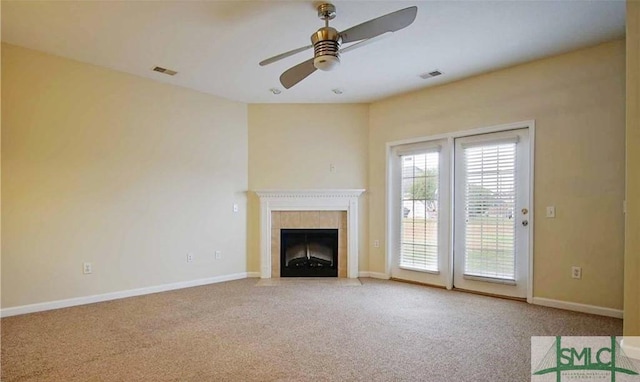 unfurnished living room featuring carpet flooring, ceiling fan, and a fireplace