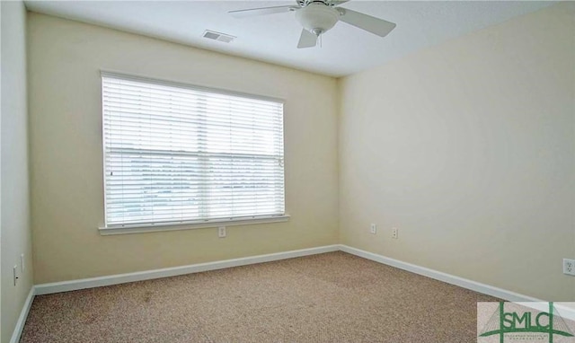 carpeted empty room featuring ceiling fan