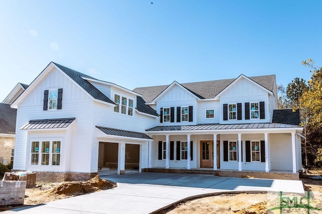 modern farmhouse style home featuring covered porch