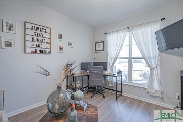 home office with hardwood / wood-style floors