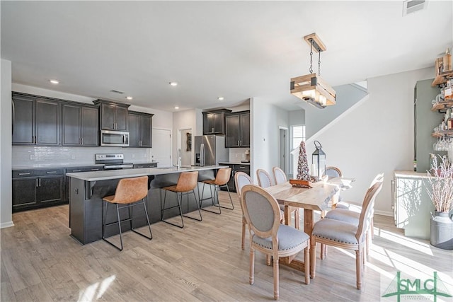 dining room featuring light hardwood / wood-style flooring and sink