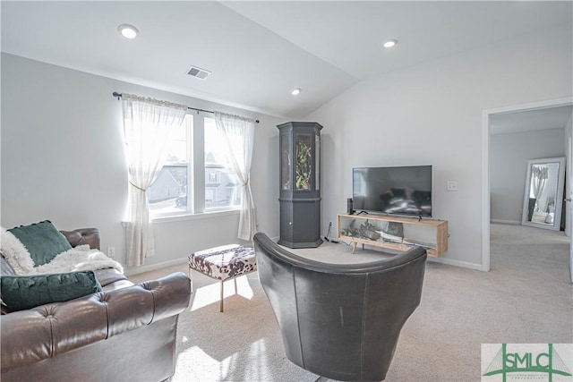 carpeted living room featuring vaulted ceiling