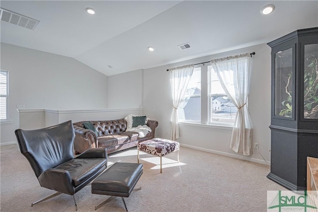 living room featuring light colored carpet and lofted ceiling