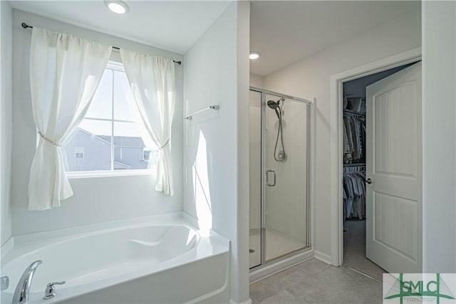 bathroom featuring separate shower and tub