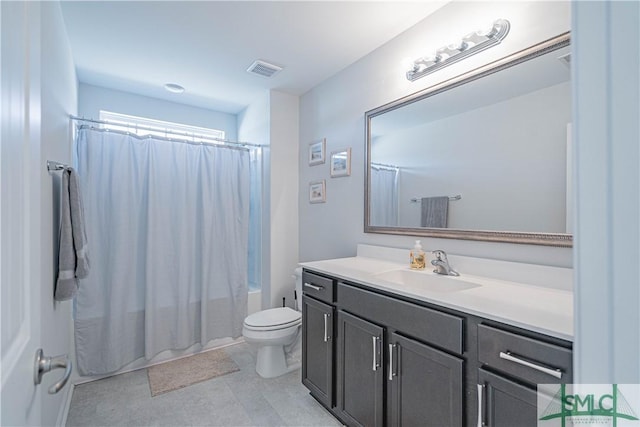 full bathroom with vanity, toilet, and shower / tub combo