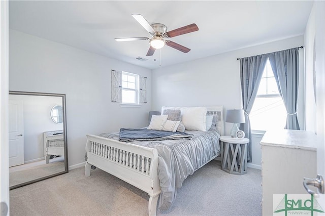 carpeted bedroom with ceiling fan and multiple windows