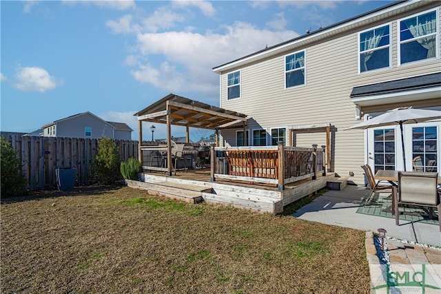 rear view of property with a lawn, a pergola, a patio area, and a deck