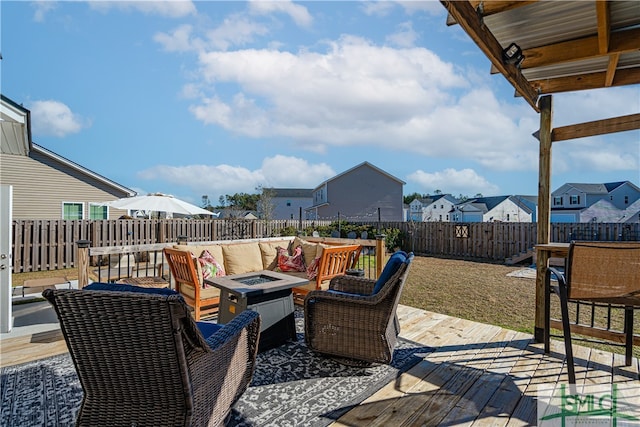 deck featuring an outdoor living space with a fire pit