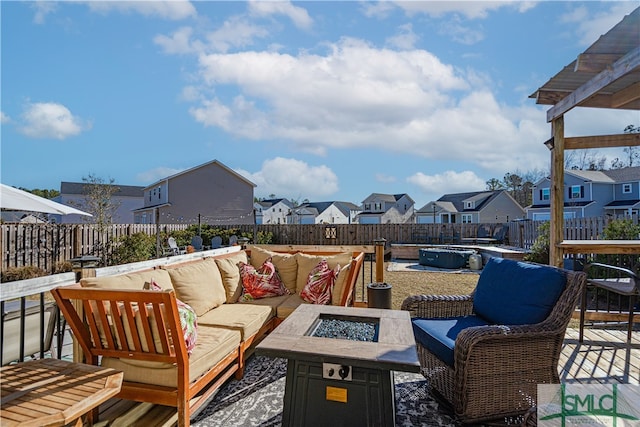 view of patio / terrace featuring a covered pool and an outdoor living space with a fire pit