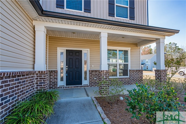 view of exterior entry with covered porch