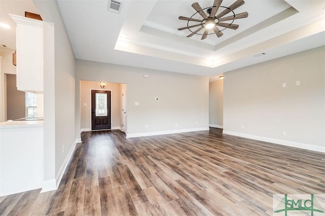 127 Winding Way Rd, Pembroke, GA 31321 - unfurnished living room with a tray ceiling, ceiling fan, wood finished floors, and crown molding