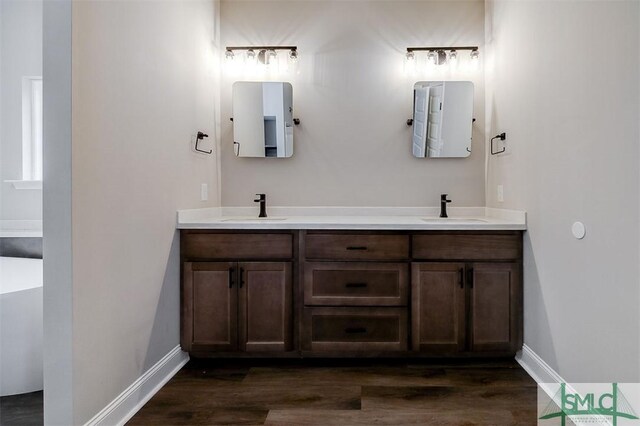 127 Winding Way Rd, Pembroke, GA 31321 - full bath with double vanity, wood finished floors, and a soaking tub
