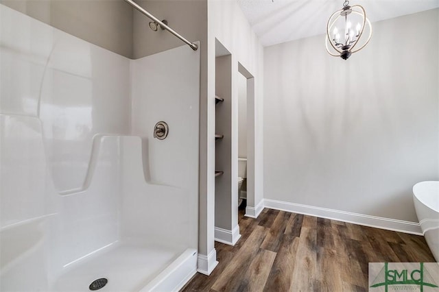 127 Winding Way Rd, Pembroke, GA 31321 - bathroom featuring wood finished floors, a shower, a chandelier, and a soaking tub
